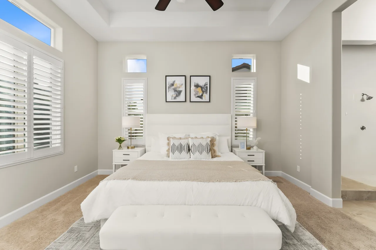 Bright primary bedroom with plantation shutters