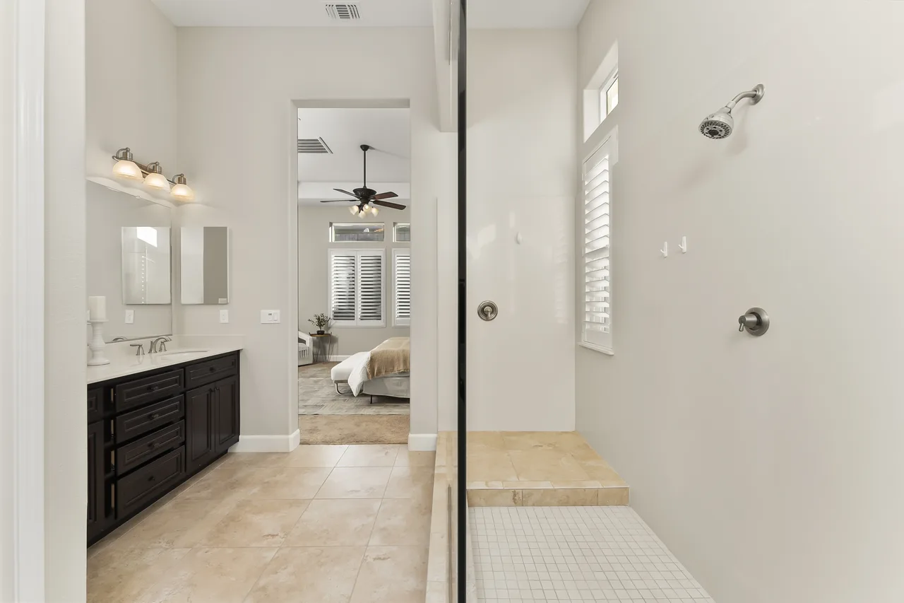 Spa-style primary bathroom with double vanity