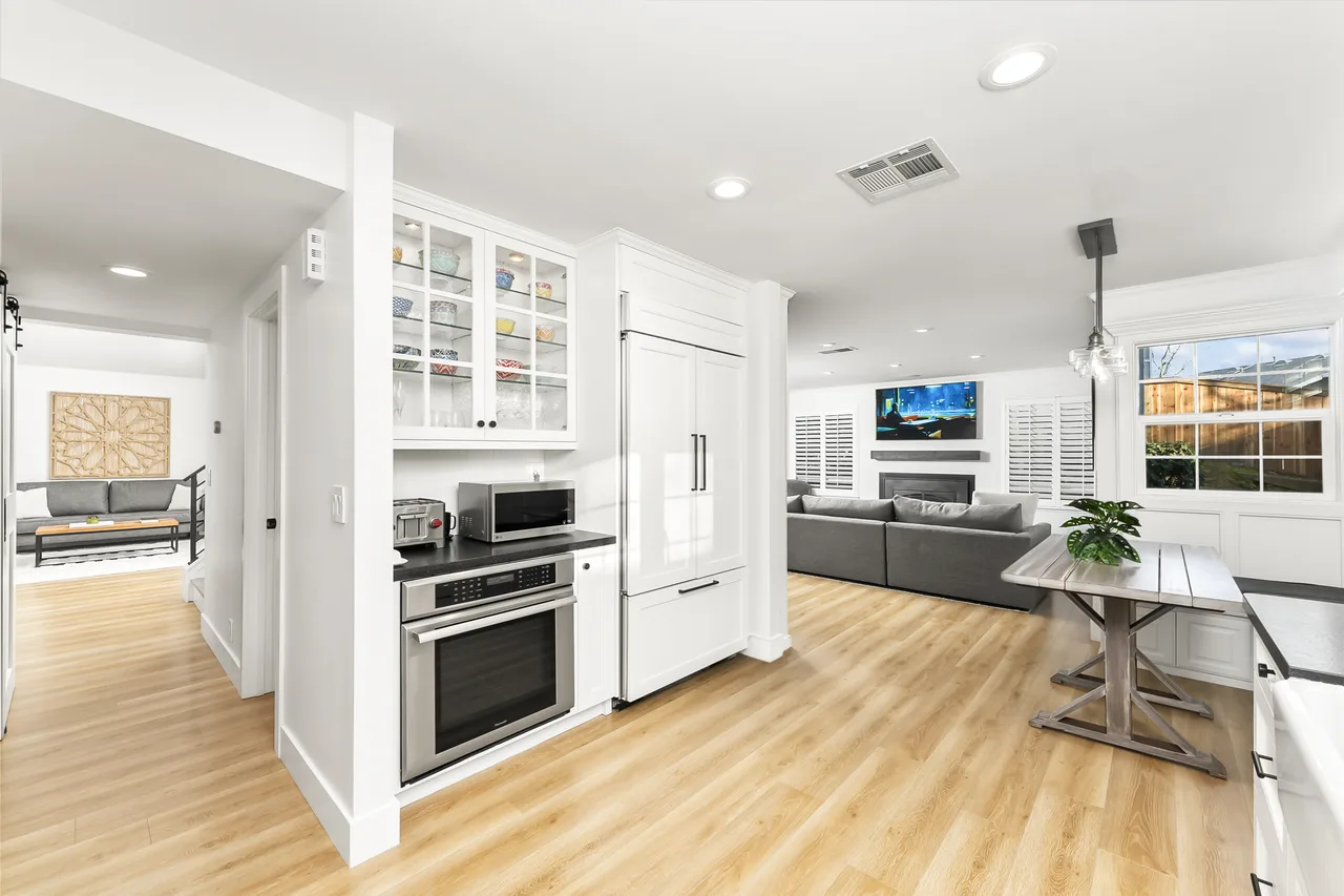 Open kitchen with grey sectional and built-in television