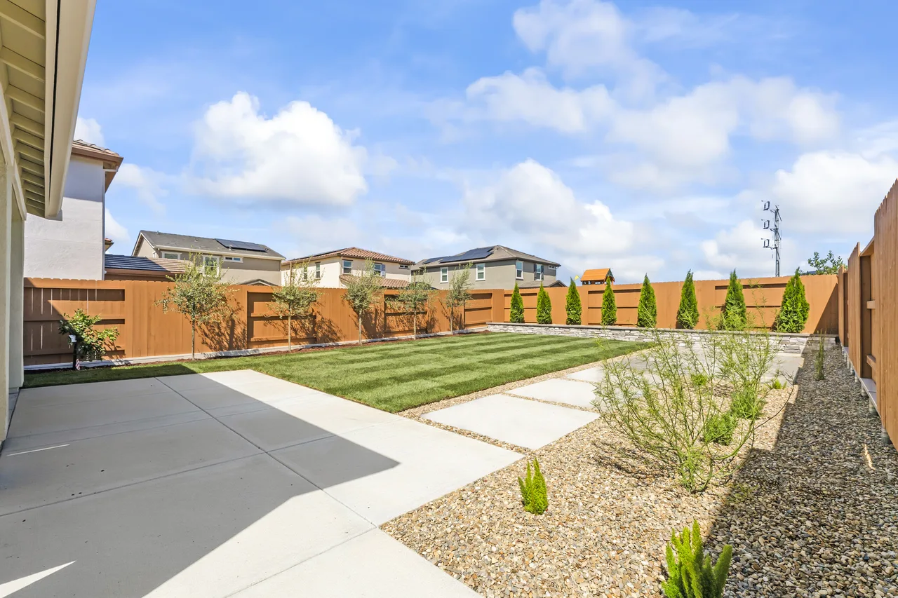 Newly landscaped backyard with paver walkway