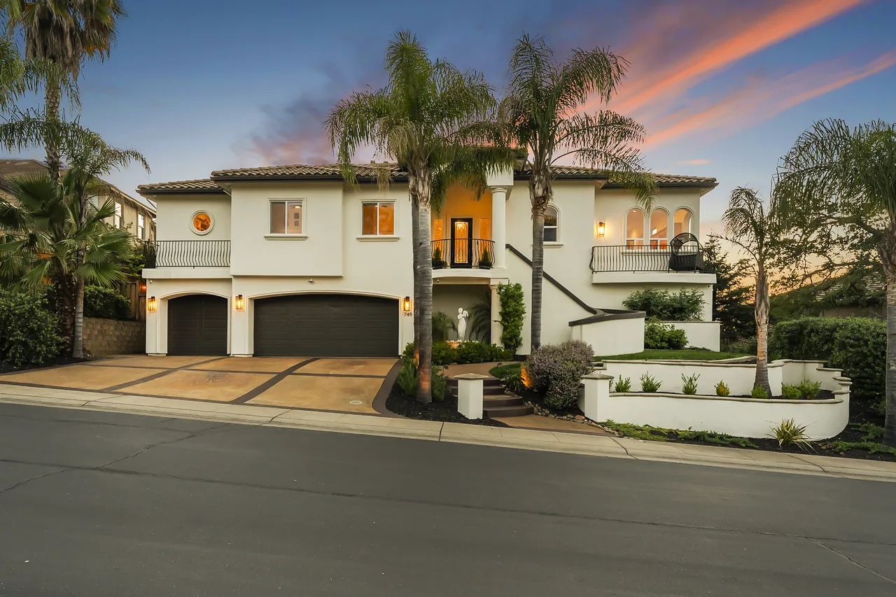Mediterranean home at twilight with sunset sky