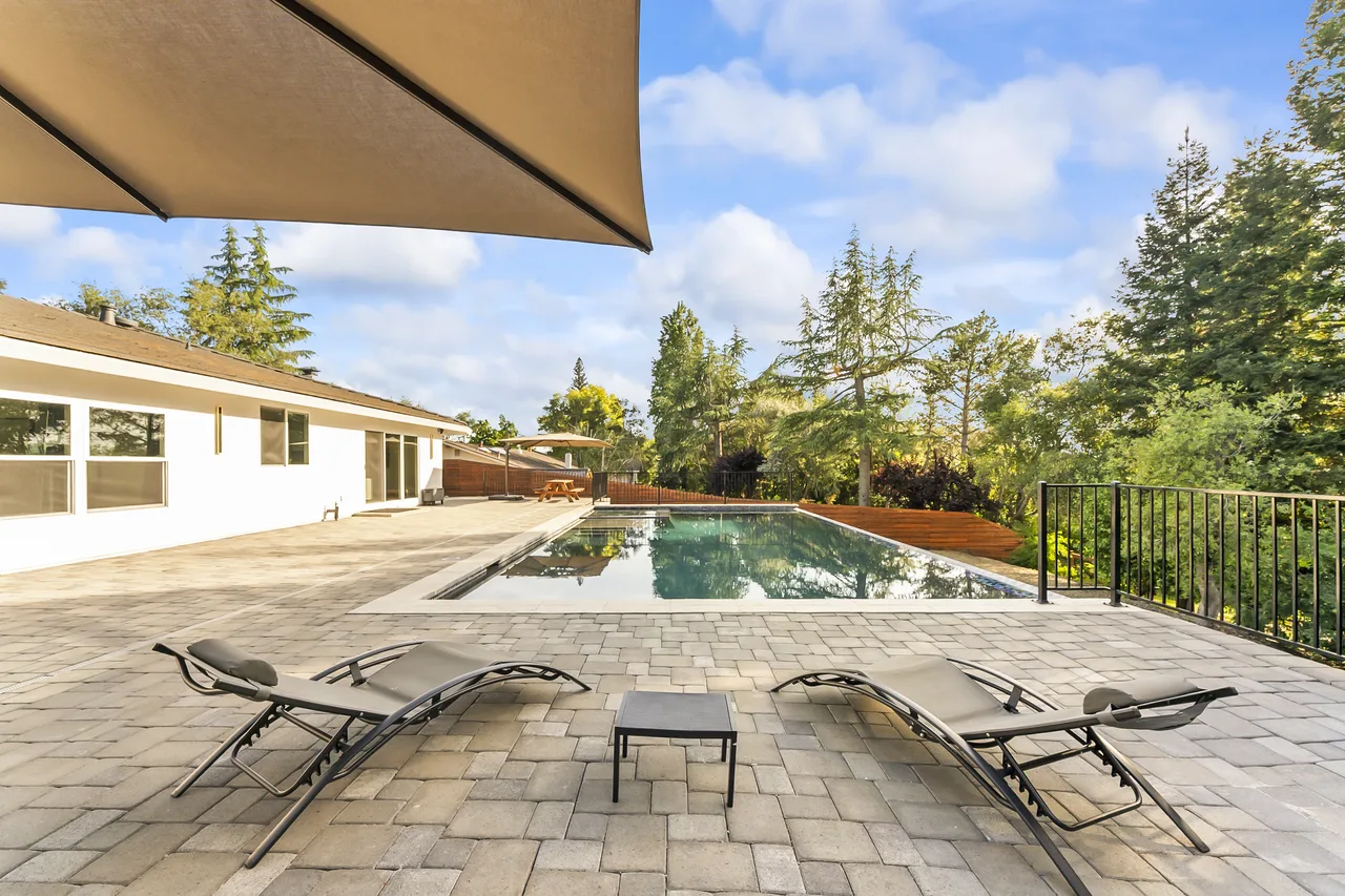 Pool patio with chaise lounges and view