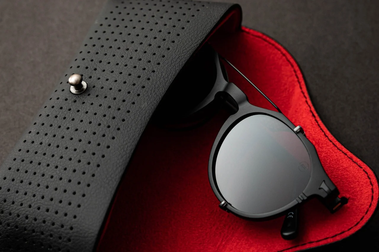 Designer sunglasses on red leather case