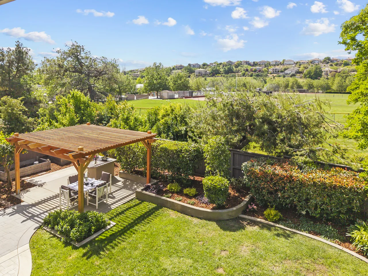 Backyard pergola overlooking open space