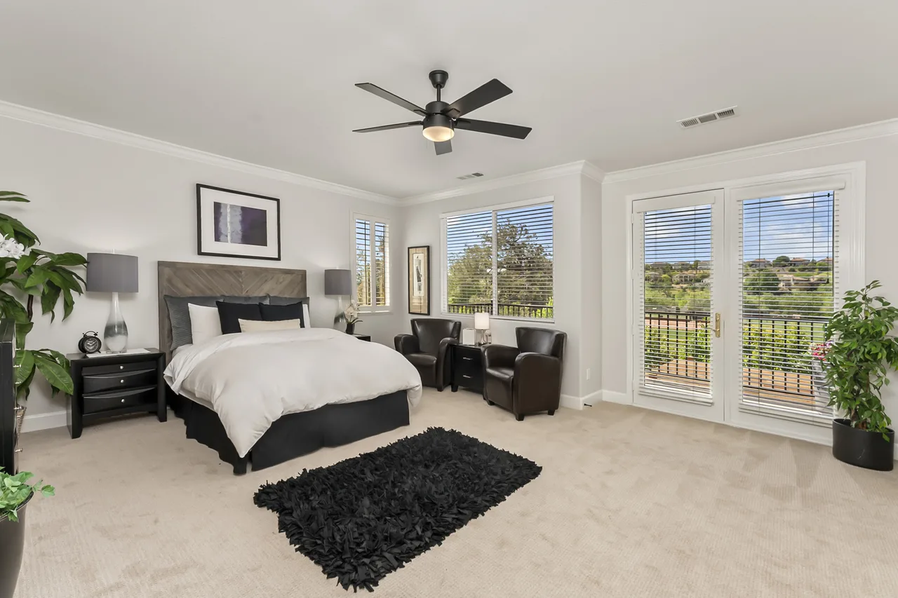 Spacious primary bedroom with ceiling fan